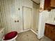 Bathroom includes a shower, toilet, vanity, and unique wallpaper for added charm at 328 Cone Dr, Henderson, NC 27537