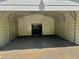 Inside the metal carport, a gravel floor and metal walls provide shelter at 328 Cone Dr, Henderson, NC 27537