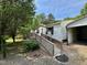 Exterior view of a home with a deck, ramp, and carport at 328 Cone Dr, Henderson, NC 27537