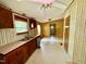 Kitchen with wooden cabinets, linoleum floors, a ceiling fan, and a double basin sink at 328 Cone Dr, Henderson, NC 27537