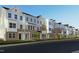 Row of new townhomes featuring a sidewalk and landscaped front yards at 336 Chesapeak Commons St # 140, Garner, NC 27529