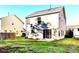 A large backyard with green grass and a home that features a sliding glass door at 3742 Marshlane Way, Raleigh, NC 27610