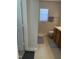 Well-lit bathroom featuring a window with blinds, a towel rack, and a vanity with wooden cabinets at 3742 Marshlane Way, Raleigh, NC 27610