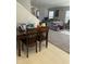 Inviting dining area with a wooden table and chairs, next to a carpeted living room at 3742 Marshlane Way, Raleigh, NC 27610