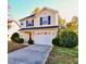 Two story home with a well maintained lawn, a driveway, and an attached garage at 3742 Marshlane Way, Raleigh, NC 27610