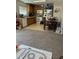 Kitchen with wood cabinets and appliances adjacent to carpeted living room and kitchen table at 3742 Marshlane Way, Raleigh, NC 27610