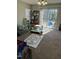 Living room boasts carpet flooring and natural light from sliding glass doors at 3742 Marshlane Way, Raleigh, NC 27610