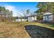 Expansive backyard with mature trees and outbuildings, offering privacy and space for outdoor enjoyment at 409 S 13Th St, Lillington, NC 27546