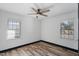 Bright and airy bedroom with a ceiling fan, wood-look floors, and large windows letting in plenty of light at 409 S 13Th St, Lillington, NC 27546