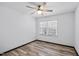 Bright bedroom with a ceiling fan and wood-look flooring, illuminated by natural light through large windows at 409 S 13Th St, Lillington, NC 27546