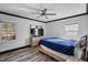 Cozy bedroom featuring ceiling fan, wood-look flooring, and ample natural light creating a welcoming atmosphere at 409 S 13Th St, Lillington, NC 27546