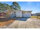 A one-story home with a large driveway and a partially screened patio addition at 409 S 13Th St, Lillington, NC 27546