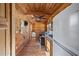 Compact home with a kitchen, living, and bedroom areas featuring wood paneling and a ceiling fan at 409 S 13Th St, Lillington, NC 27546