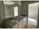 Primary bathroom featuring double sink vanity with granite counters, and a large mirror at 42 Heatherglenn Cir, Princeton, NC 27569