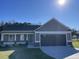 Charming single-story home featuring a two-car garage and manicured lawn on a sunny day at 42 Heatherglenn Cir, Princeton, NC 27569