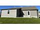 Exterior view of the home showcasing its siding, foundation, and back door, with a well-maintained lawn at 42 Heatherglenn Cir, Princeton, NC 27569