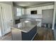 Modern kitchen featuring granite countertops, a kitchen island, and white cabinets at 42 Heatherglenn Cir, Princeton, NC 27569