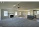 Bright and airy living room with a fireplace and ceiling fan, adjacent to the modern kitchen at 42 Heatherglenn Cir, Princeton, NC 27569