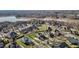 Picturesque aerial view of the neighborhood's well-manicured lawns next to a scenic lake, highlighting the community's natural beauty at 4278 Aviemore, Burlington, NC 27215