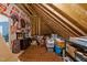 Spacious attic storage area, featuring exposed wooden beams, shelving, and various storage bins and containers at 4278 Aviemore, Burlington, NC 27215