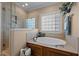 This bathroom features a soaking tub, a walk-in shower with glass door, and tile surround at 4278 Aviemore, Burlington, NC 27215