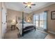 Comfortable bedroom with four-poster bed, ceiling fan, and ample natural light from the window at 4278 Aviemore, Burlington, NC 27215