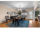 Inviting dining room with hardwood floors, a chandelier, and an adjacent view to the kitchen at 4278 Aviemore, Burlington, NC 27215