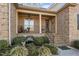 Inviting front porch featuring classic brickwork, outdoor seating, and a charming entrance at 4278 Aviemore, Burlington, NC 27215