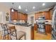 Open kitchen with stainless steel appliances, granite countertops, and bar stool seating at 4278 Aviemore, Burlington, NC 27215