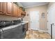 This laundry room features tile floor, overhead cabinets, a utility sink, and a stainless washer and dryer at 4278 Aviemore, Burlington, NC 27215