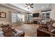 Cozy living room with a stone fireplace, built-in bookshelves, and large windows at 4278 Aviemore, Burlington, NC 27215