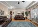 Spacious living room with hardwood floors, leather furniture, and an open view to the dining area at 4278 Aviemore, Burlington, NC 27215