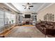 Comfortable living room featuring a stone fireplace, built-in shelving, and natural light at 4278 Aviemore, Burlington, NC 27215