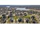 Aerial view of a residential community with well-maintained homes and lawns, near a tranquil lake at 4278 Aviemore, Burlington, NC 27215