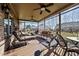 This patio features a screen enclosure, ceiling fans, and outdoor furniture with a view to the backyard at 4278 Aviemore, Burlington, NC 27215