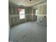 Unfinished bedroom with two windows and an entry to another room at 432 E Clydes Point Way, Wendell, NC 27591