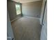 Bedroom featuring neutral walls, a window, and a door at 432 E Clydes Point Way, Wendell, NC 27591