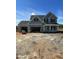 Two-story blue home with a three-car garage and black shutters, under construction at 432 E Clydes Point Way, Wendell, NC 27591
