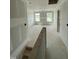 Hallway with drywall ready for customization leading to bedrooms with windows providing natural light at 432 E Clydes Point Way, Wendell, NC 27591