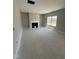 Bright living room featuring a classic fireplace and large window with natural light at 432 E Clydes Point Way, Wendell, NC 27591