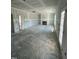Unfinished living room featuring a fireplace, large windows, and an entry to another room at 432 E Clydes Point Way, Wendell, NC 27591