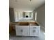 Spacious open floor plan with kitchen island leading to a living area with a fireplace at 432 E Clydes Point Way, Wendell, NC 27591