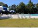 Community pool with lounge chairs and umbrellas for relaxing by the water at 432 E Clydes Point Way, Wendell, NC 27591