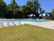 Relaxing community pool with chairs, umbrellas and well-manicured lawn space at 432 E Clydes Point Way, Wendell, NC 27591
