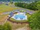 Aerial view of a community pool surrounded by lush landscaping and trees at 432 E Clydes Point Way, Wendell, NC 27591