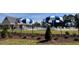 View of a community pool featuring multiple blue and white umbrellas, and trees at 432 E Clydes Point Way, Wendell, NC 27591