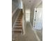 A staircase with wooden handrail leads to the upper level of this house at 432 E Clydes Point Way, Wendell, NC 27591