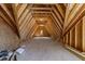 Unfinished attic space revealing wooden framing and plywood walls, offering potential for customization and expansion at 4501 Bartlett Dr, Raleigh, NC 27609