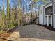 An expansive view of the partially lawned backyard with trees beyond at 4501 Bartlett Dr, Raleigh, NC 27609