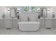Bright bathroom with freestanding tub, double vanities with framed mirrors and modern hardware at 4501 Bartlett Dr, Raleigh, NC 27609